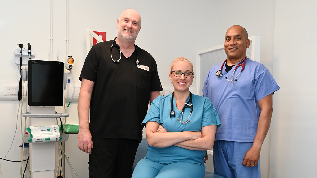 Large group of nurses protesting with signs and flags